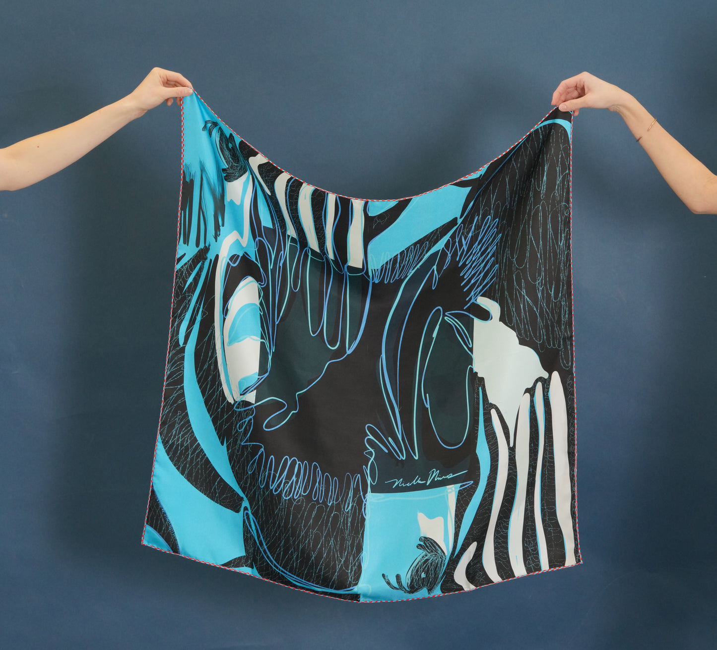 zebra print silk scarf- black and blue with red checkered border.