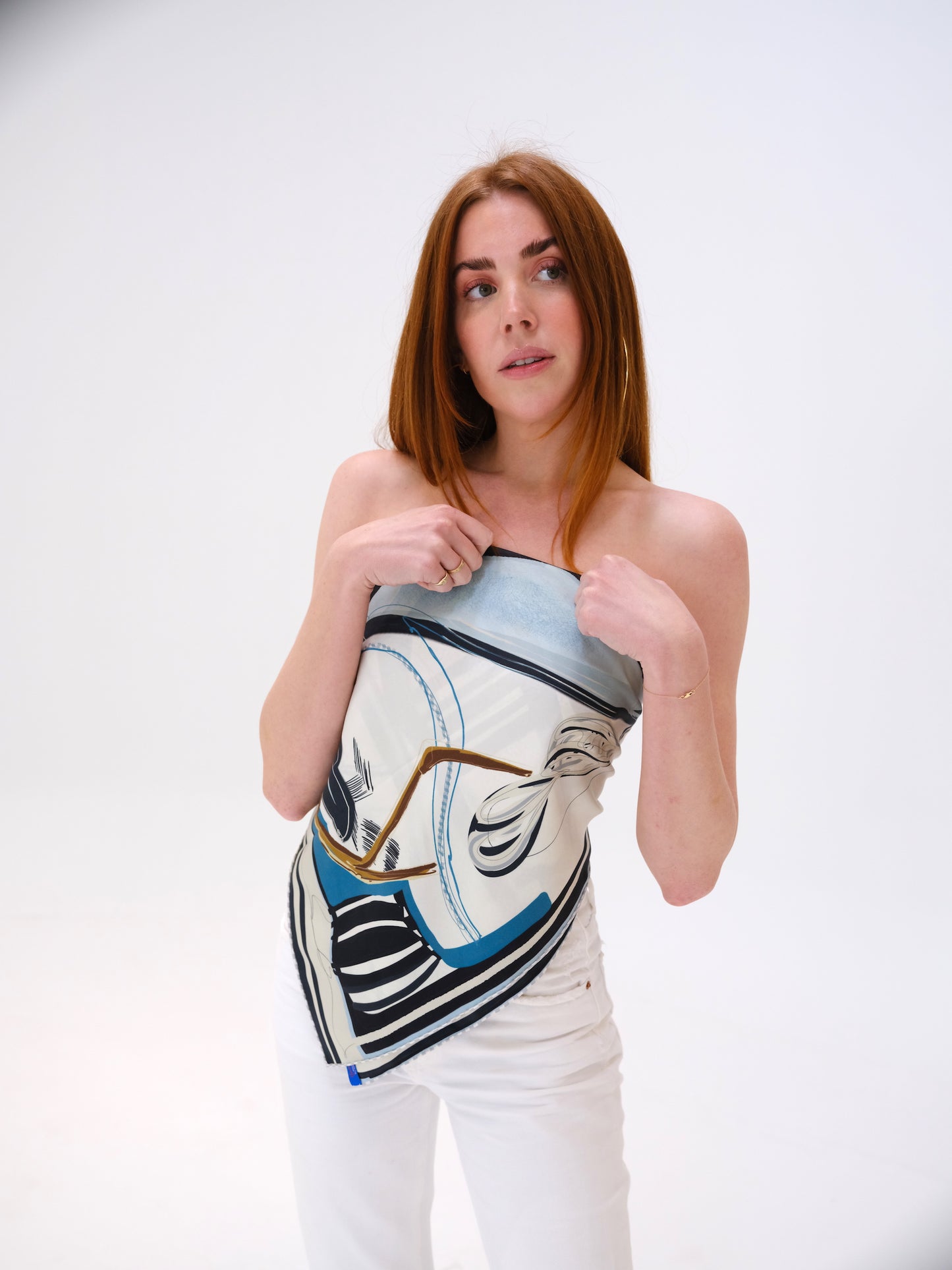 woman wearing a hounds scarf top with white jeans