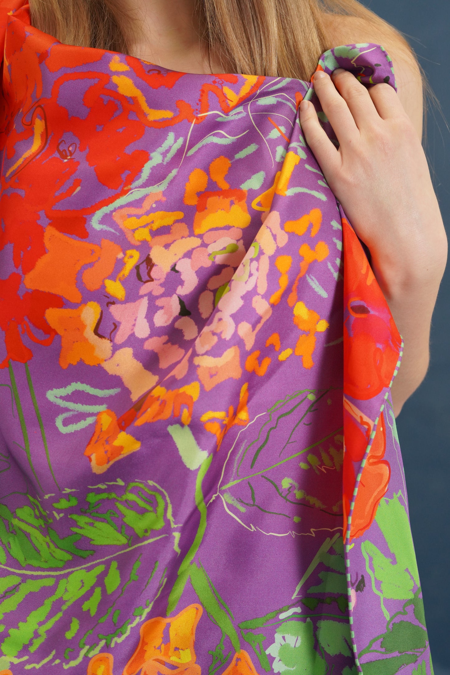 woman draped in lantana pattern purple silk scarf