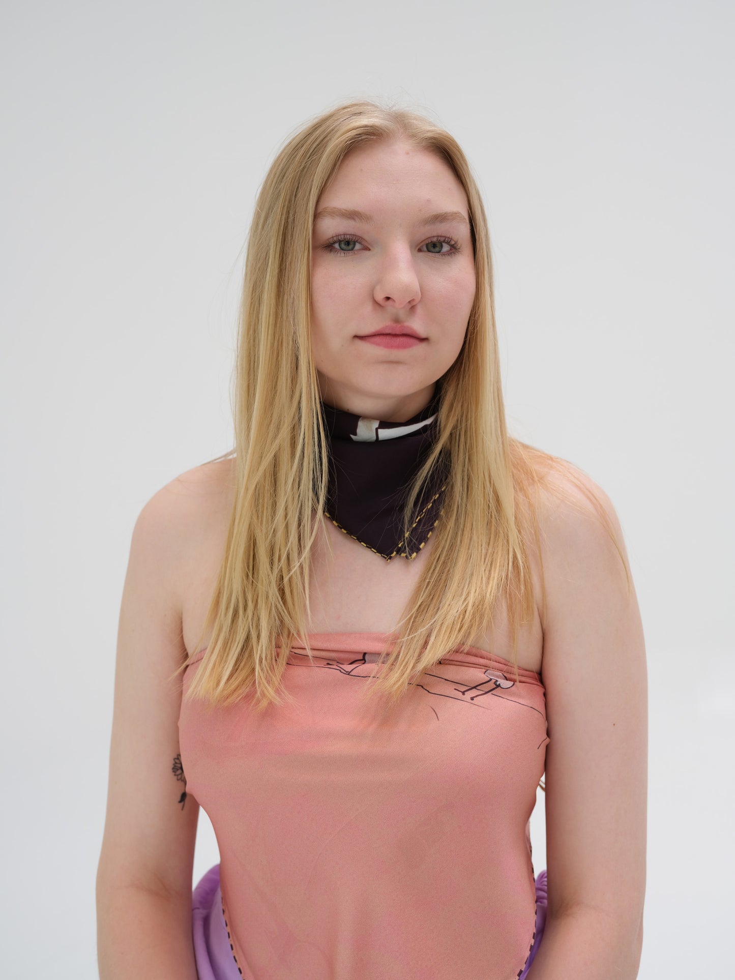 woman wears a soft pink scarf