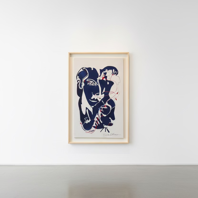 A framed art print featuring an abstract cubist-style portrait of a face in dark navy blue, white, and red linework on a light background, housed in a light wood frame.