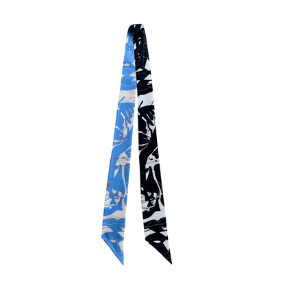 A long necktie with a split design, featuring a blue and white abstract pattern on one side and a black and white abstract pattern on the other, displayed against a plain white background.