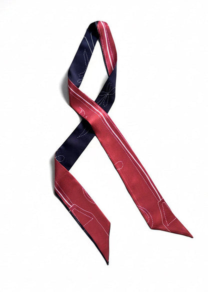A silk necktie with a red and black 
design featuring white stitched details, displayed on a clean white background.