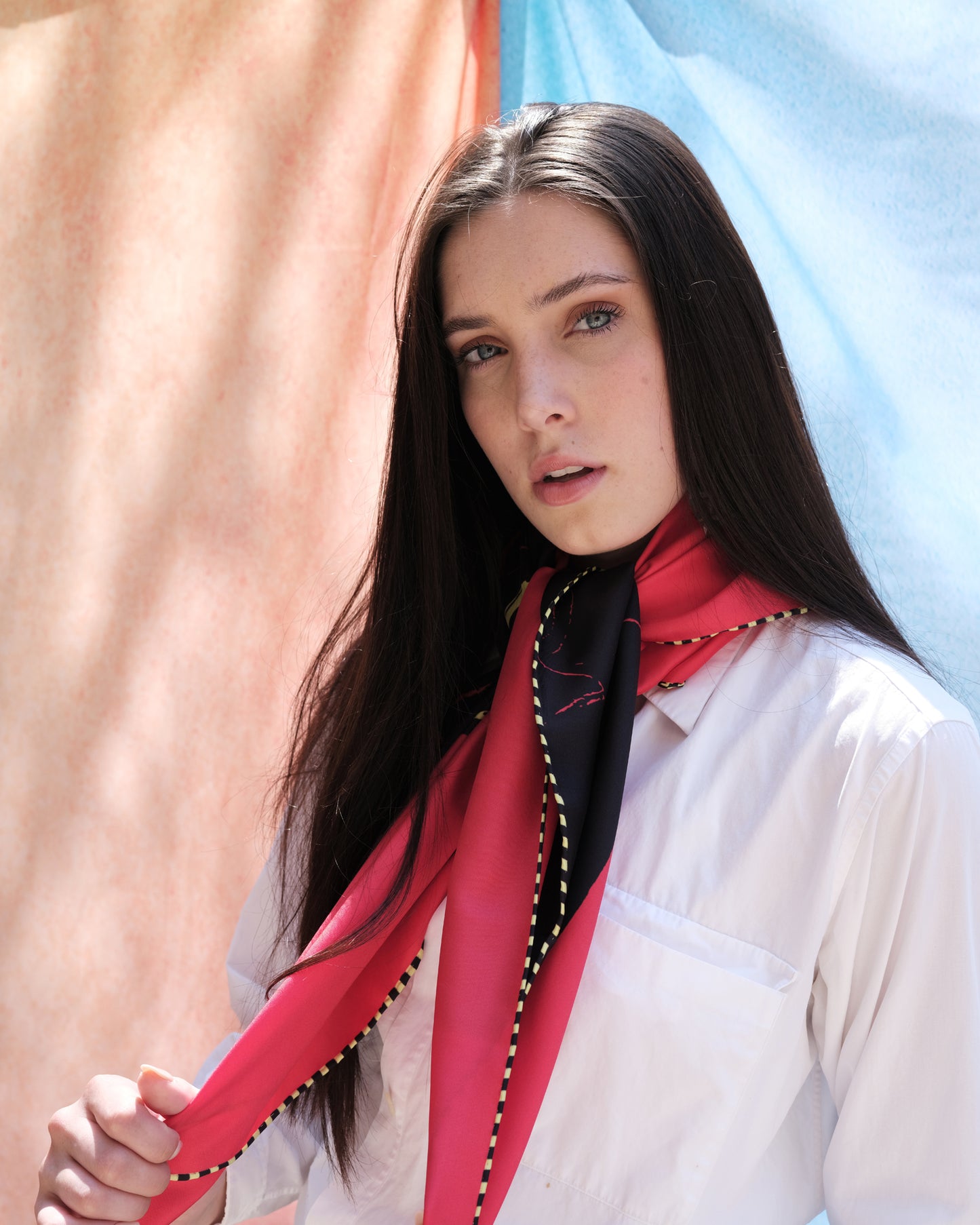 woman wearing a red silk equestrian scarf around neck 