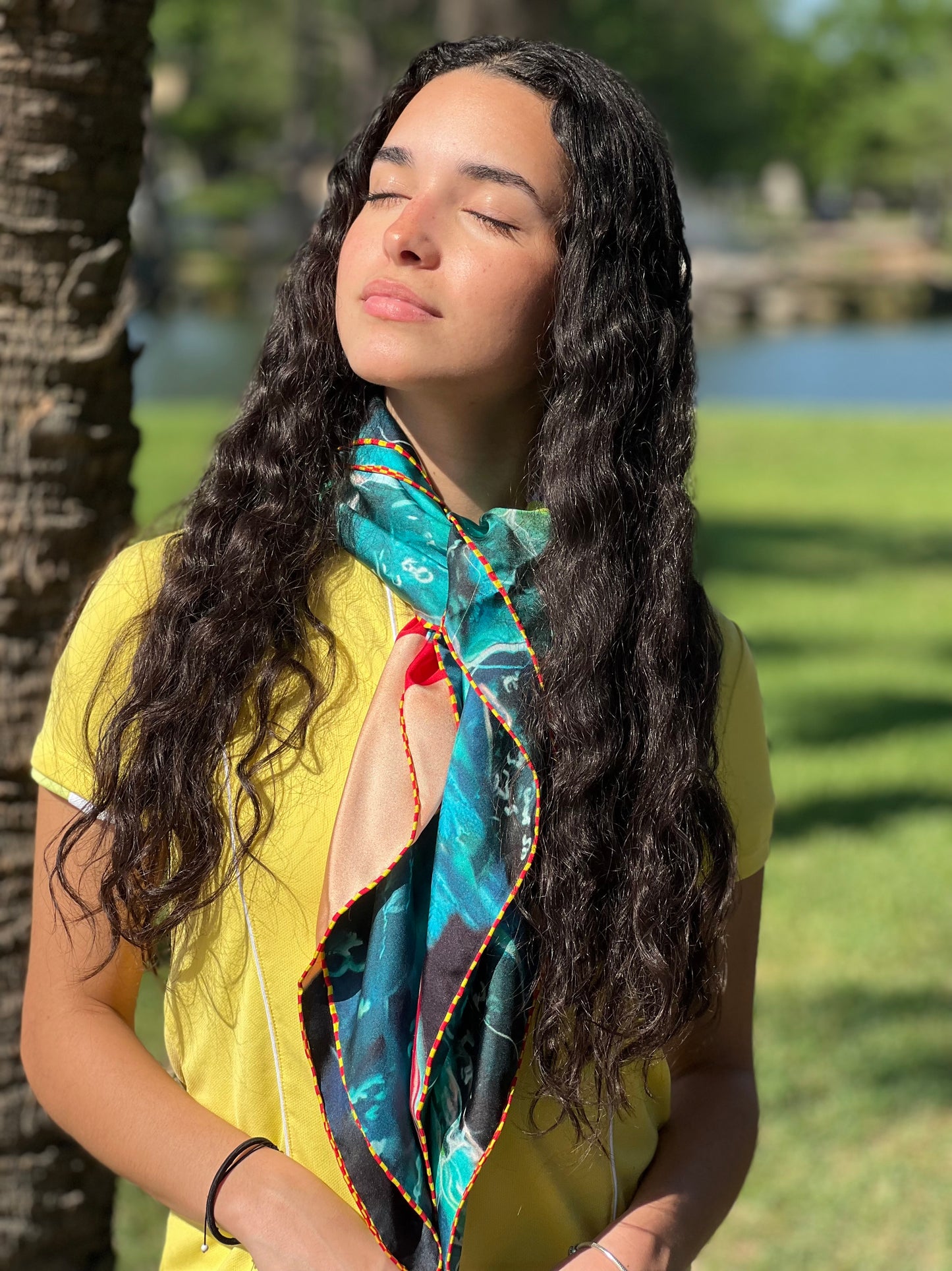 woman wearing green silk scarf around neck 