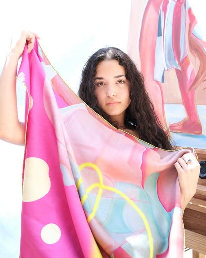 girl holding pink scarf 